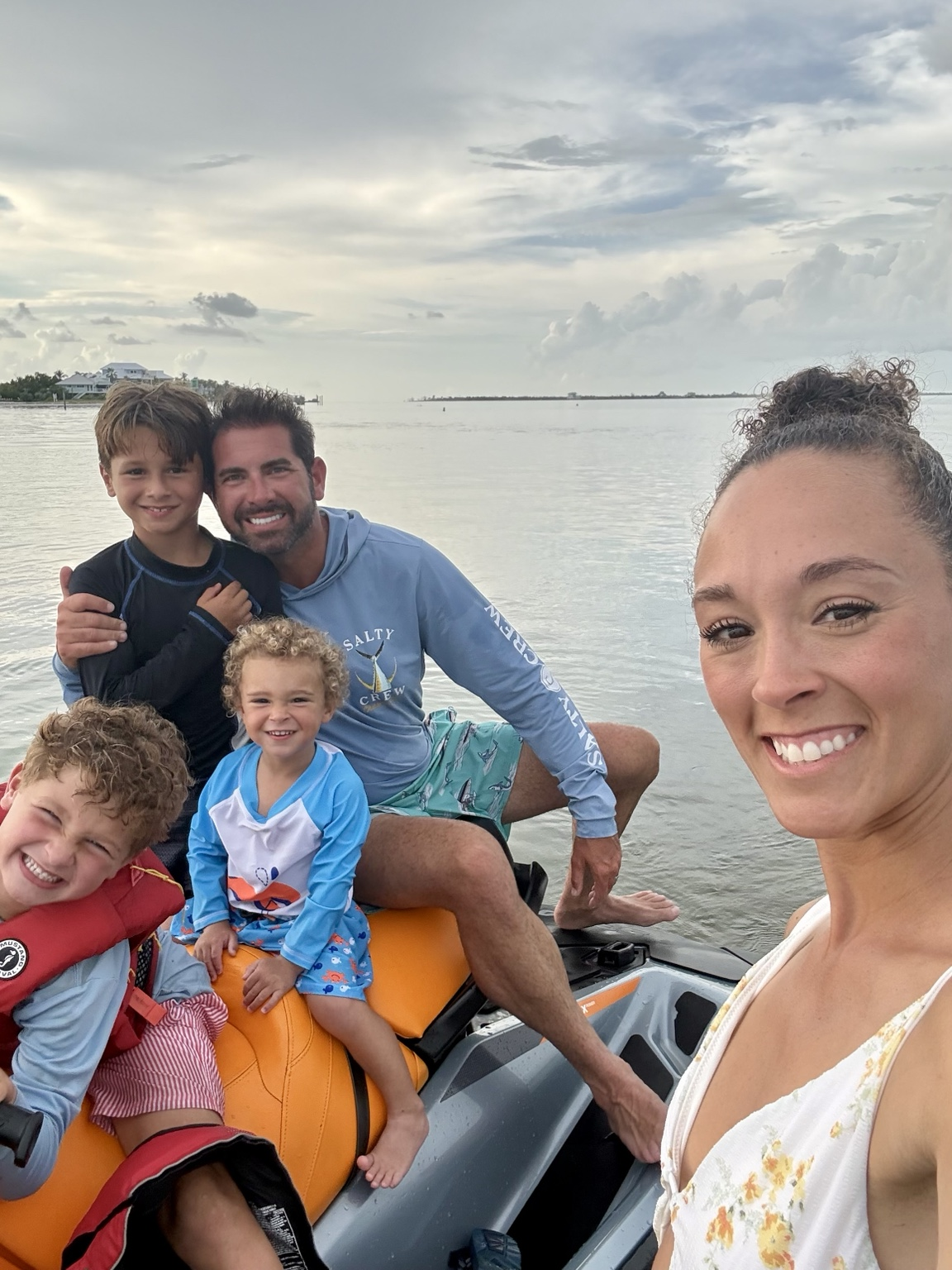 Kris, Ashley and their three sons together on the water